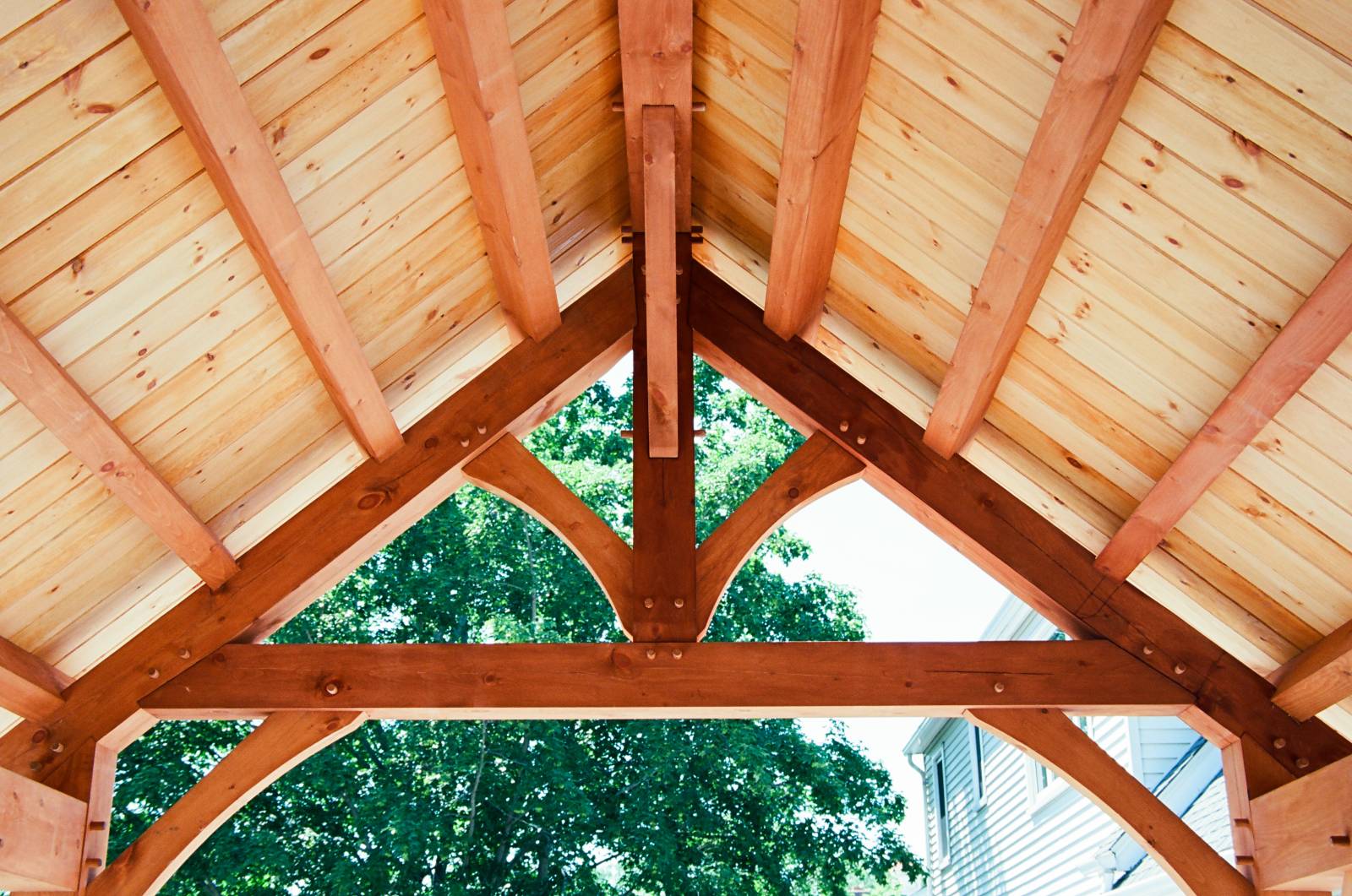 King post truss with straight bottom chord and arched braces (common purlins above)