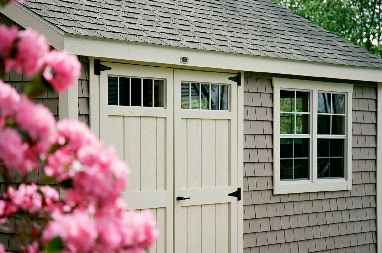 Shed with Grayne Vinyl Shake Siding (Color: Autumn Shade) • 6' Double Door with Transom Windows • 24x36 4/4 Windows with MiraTEC 1x3 Trim (Color: Navajo)