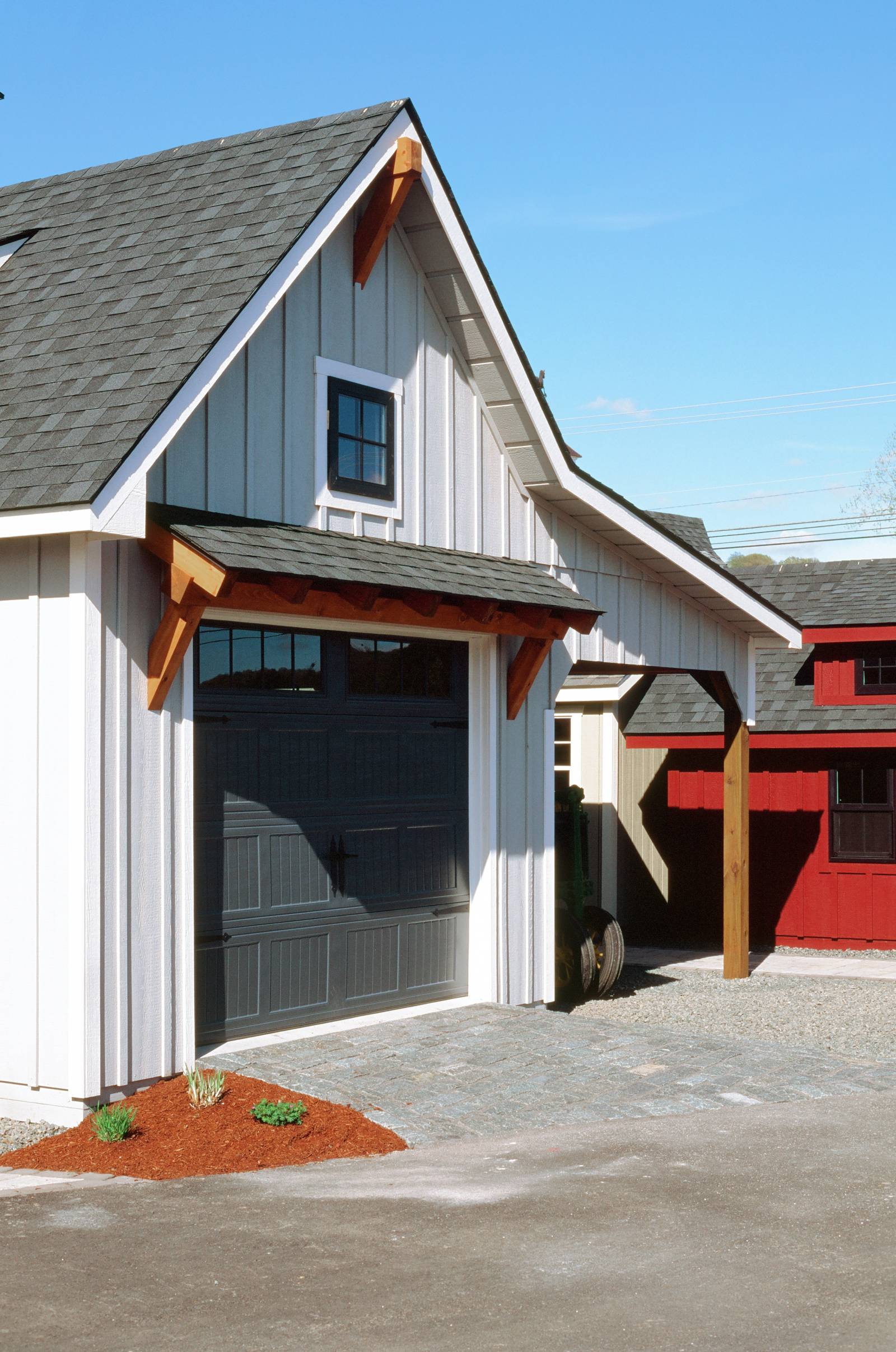 Farmhouse Details: Timber Accent • Andersen Black Window • Timber Frame Eyebrow Roof • Board & Batten Siding • Benjamin Moore Farmhouse Colors