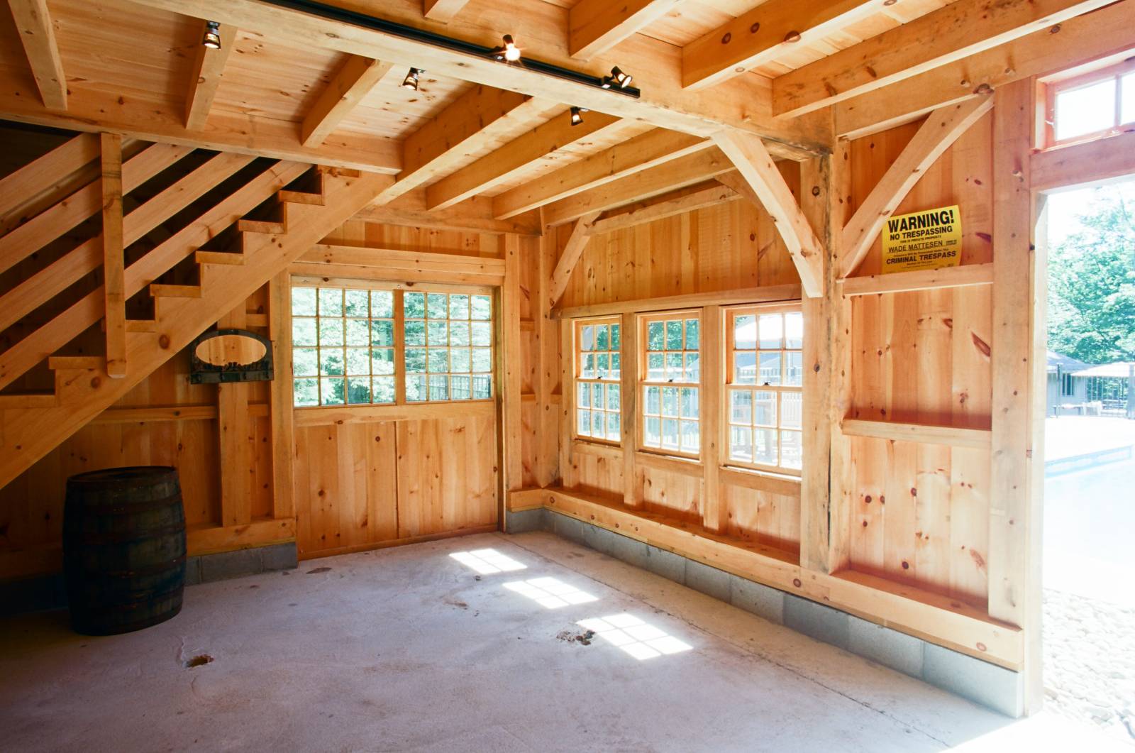 Sliding door under heavy timber stairway to second floor