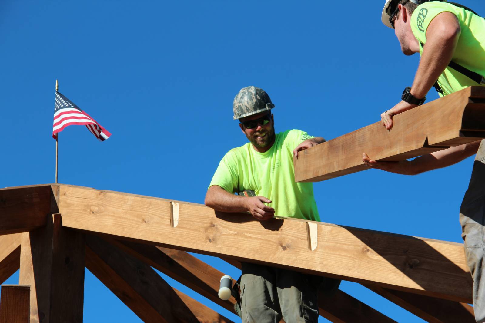 Teamwork to set the roof rafters in place