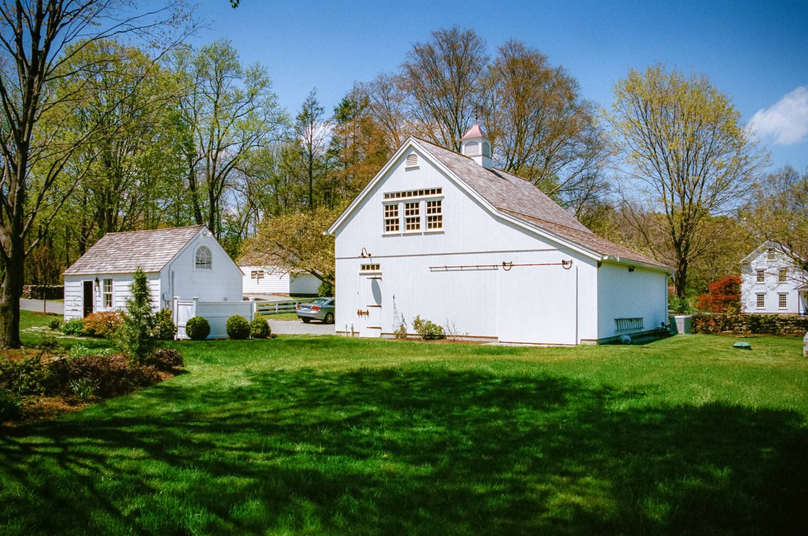 Side of the post and beam barn with sliding barn door • entry door • 10' enclosed lean-to