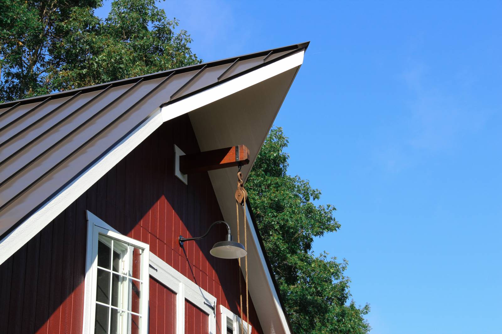 Cow Catcher Gable Peak with Standing Seam Metal Roof and Faux Trolley Beam & Pulley