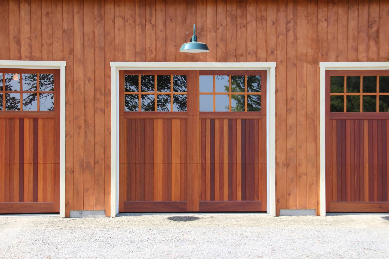 Rich Stained Overhead Doors with Glass & Gooseneck Light