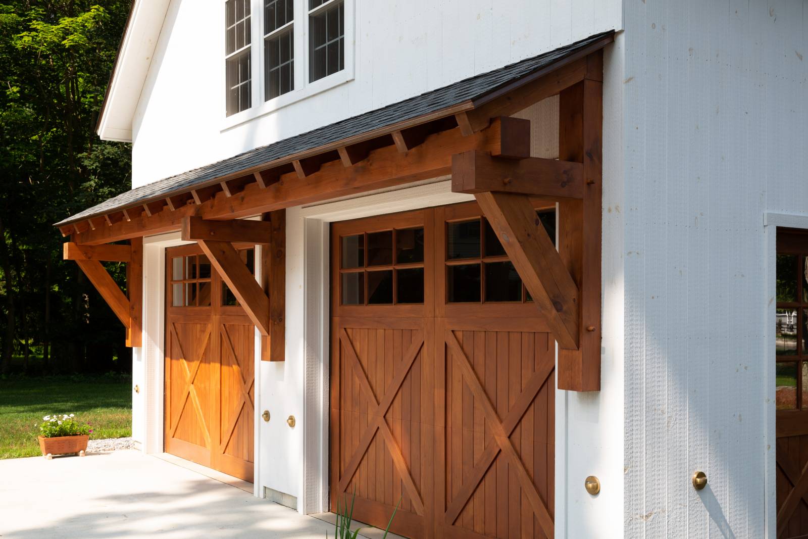 24' Big Sky Timber Frame Eyebrow Roof over Spanish Cedar Overhead Doors