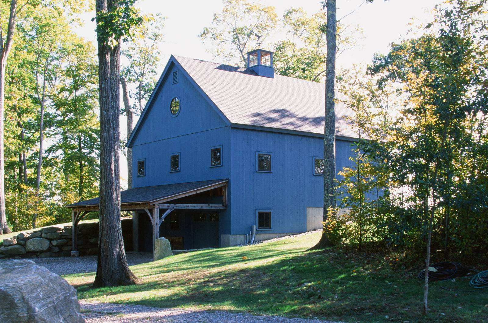 Back Angle of the Barn • Timber Frame Overhang • Garage Doors • 3 Stories