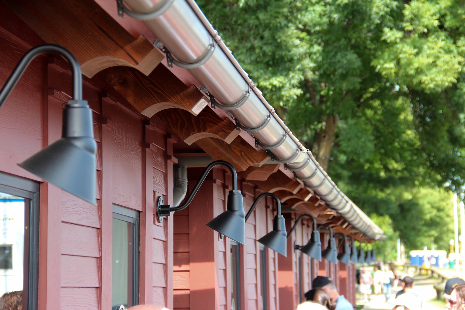 Decorative rafter tails & barn lighting on the ticket booths