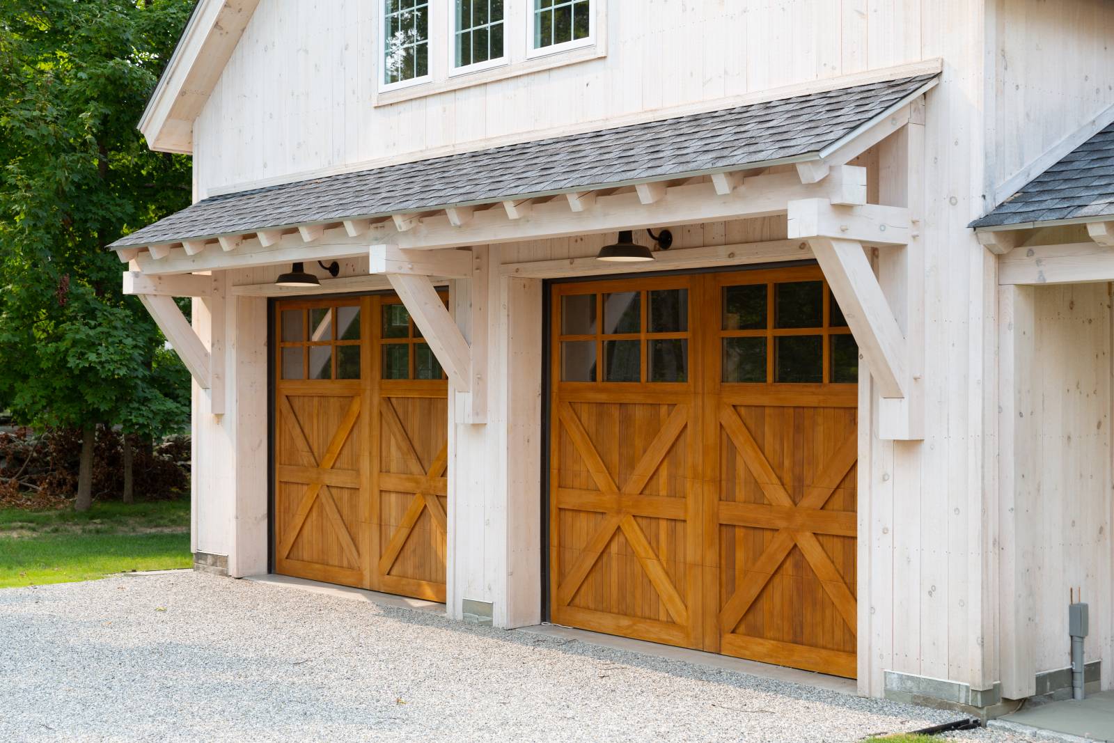 Spanish Cedar Overhead Doors • 24' Big Sky Timber Frame Eyebrow Roof
