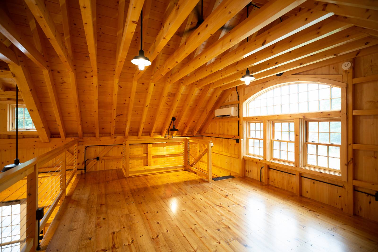 Study Loft in the Mezzanine • Bow Top Window with Double Hung Windows Below