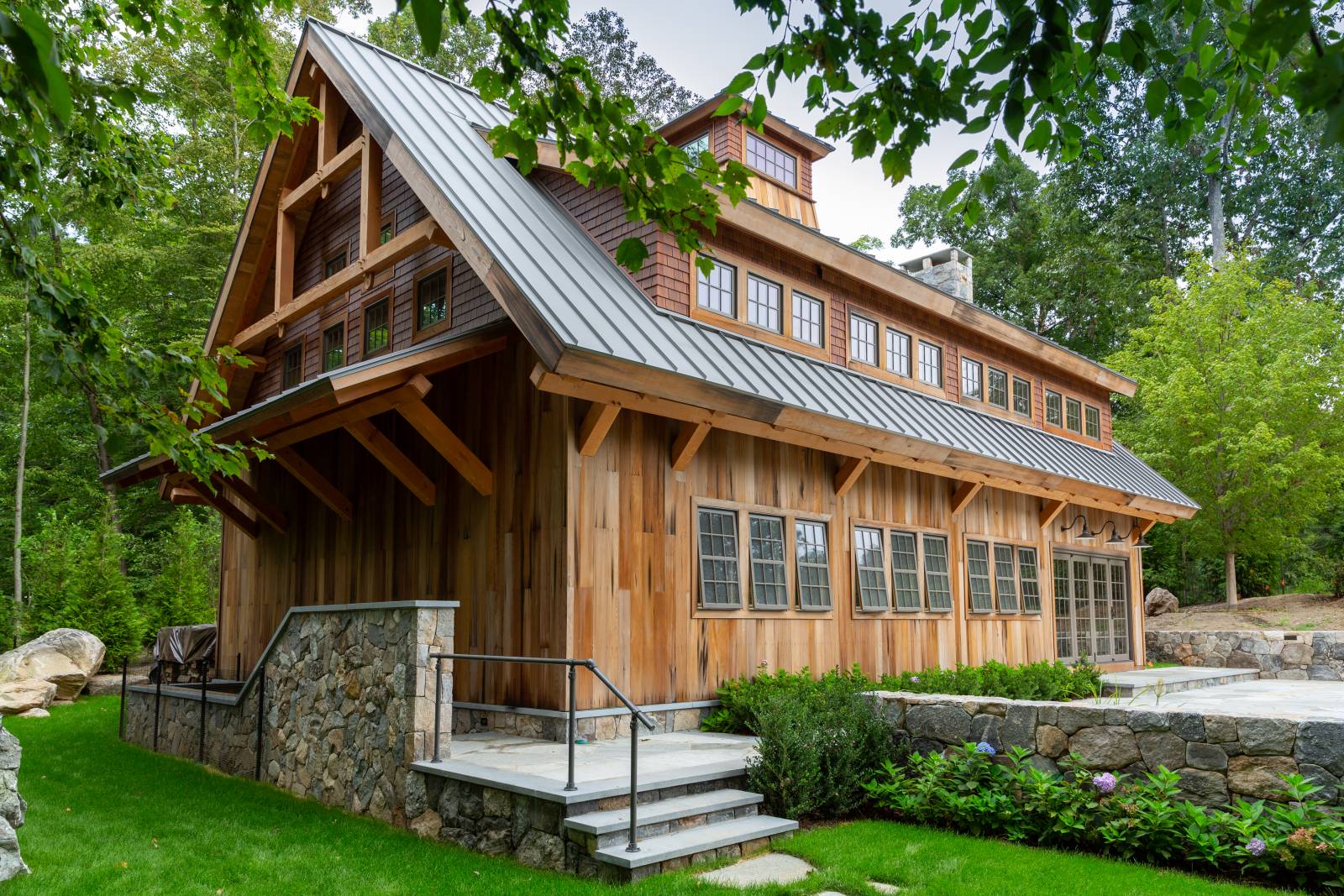 Reclaimed Barn Board Siding • Custom Eyebrow Roof • Timber Frame Accents