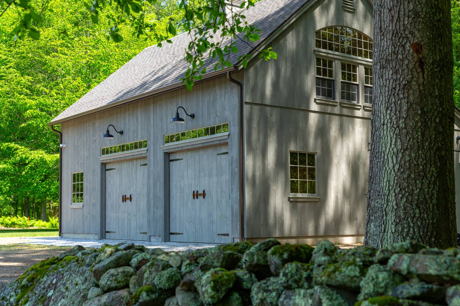 Pine-Faced Overhead Doors • Gooseneck Lights • Carriage Barn