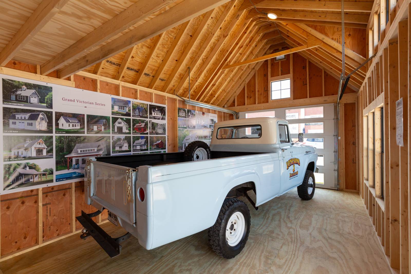 Grand Victorian Cape Garage Interior with Full View Glass Overhead Door