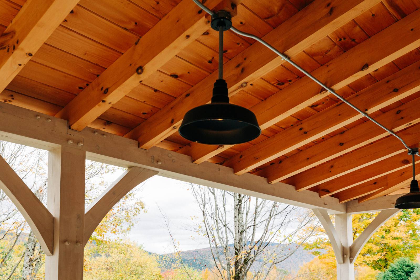 Underneath the 10' x 30' open timber frame lean-to overhang