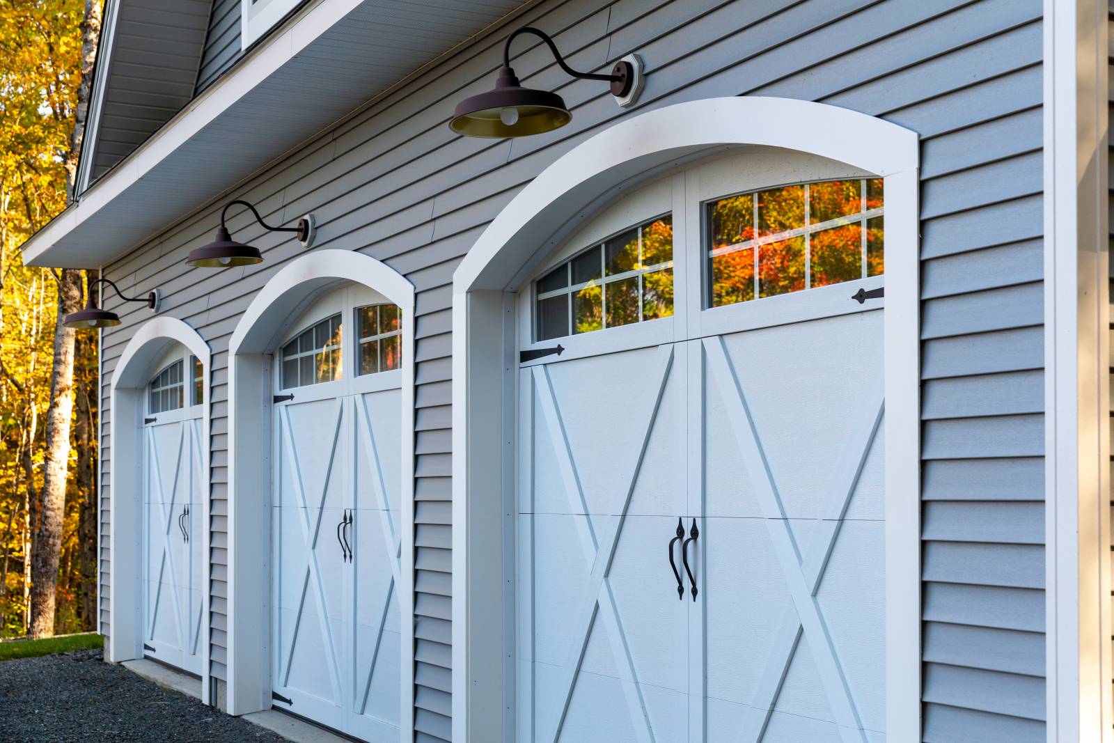 Amarr Classica steel overhead doors with glass and arched garage door trim