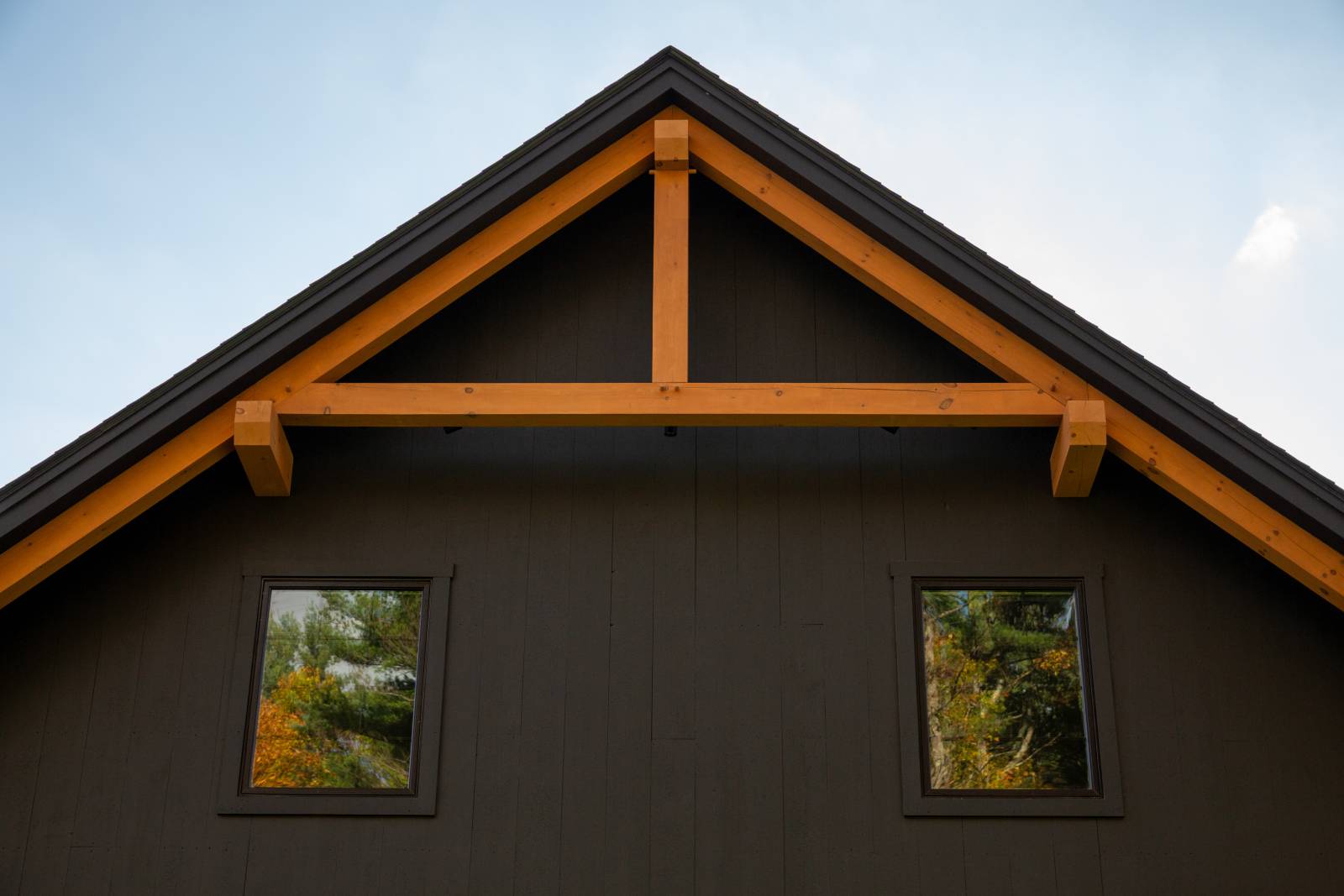 A closeup of the timber accents in the gable • Andersen 100 Series windows • ADU construction accessory dwelling unit