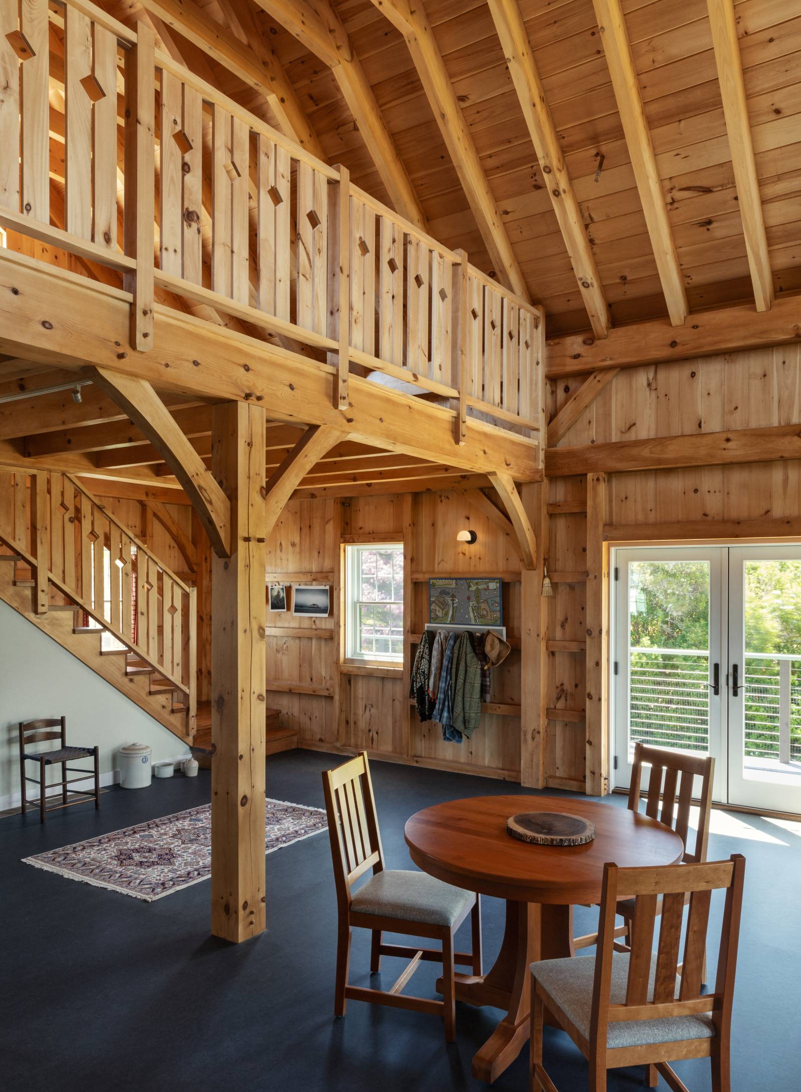 Wood furniture & railings complement the post & beam interior
