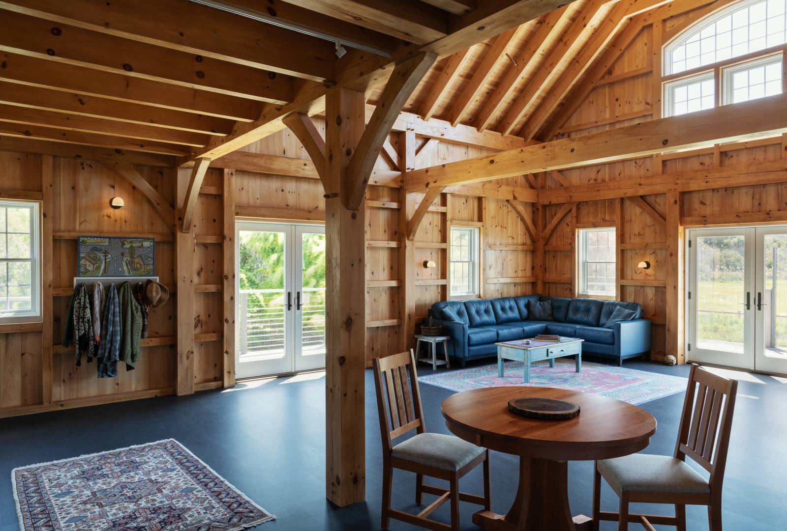 Large windows & glass doors let light into the post & beam interior
