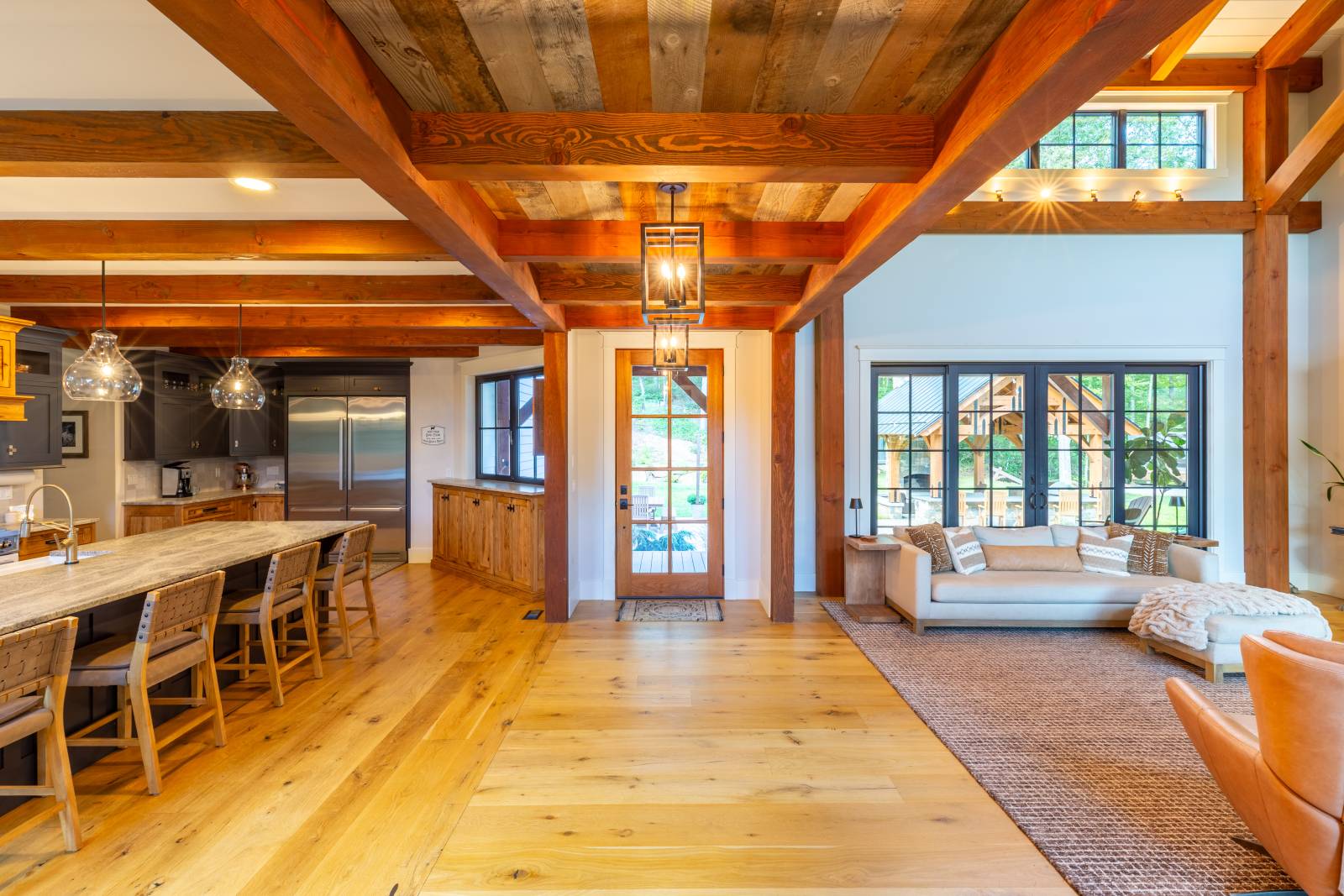 Large timbers & reclaimed barn board in the foyer between the great room & kitchen