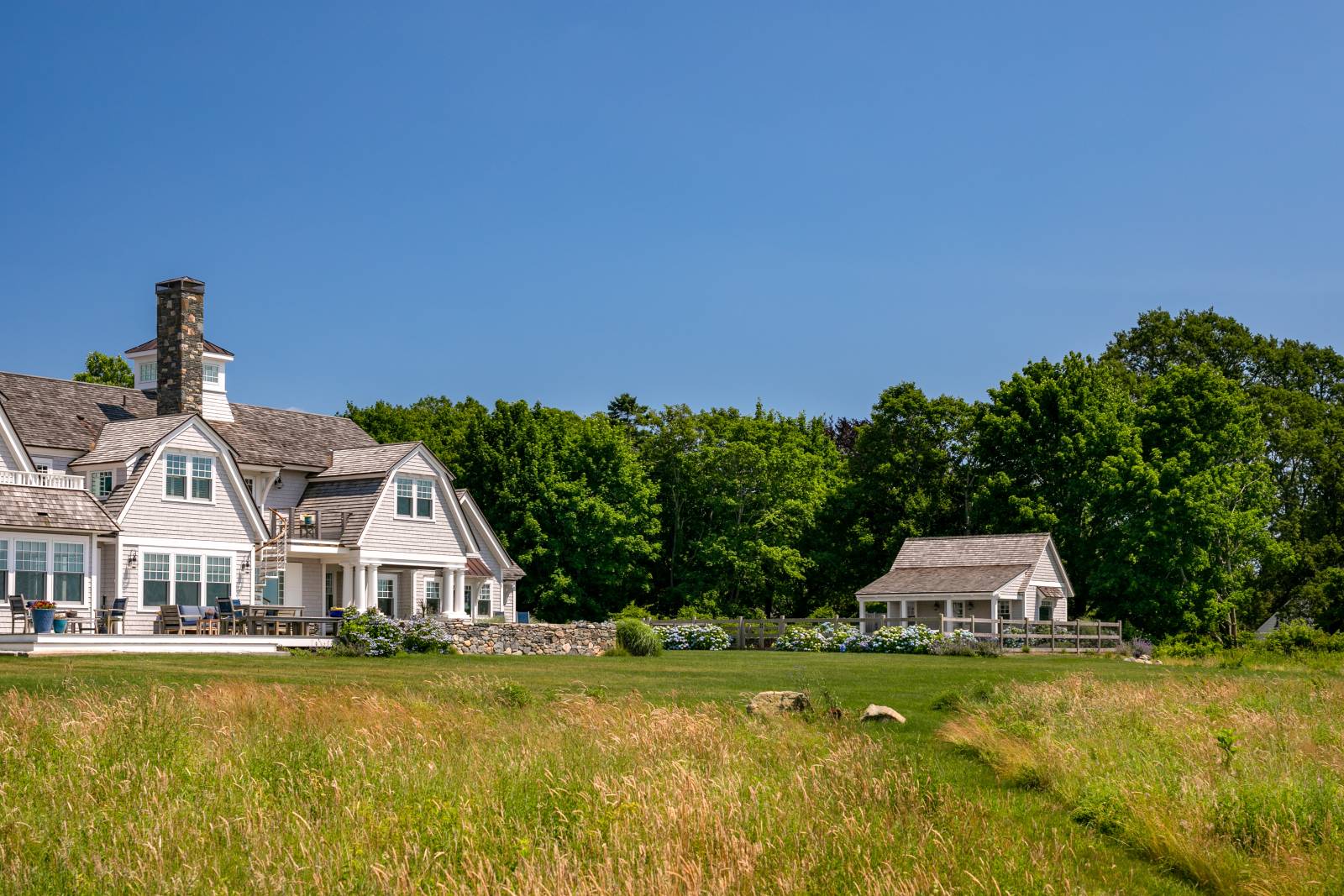 The timber frame pool house from a distance • Stunning coastal estate