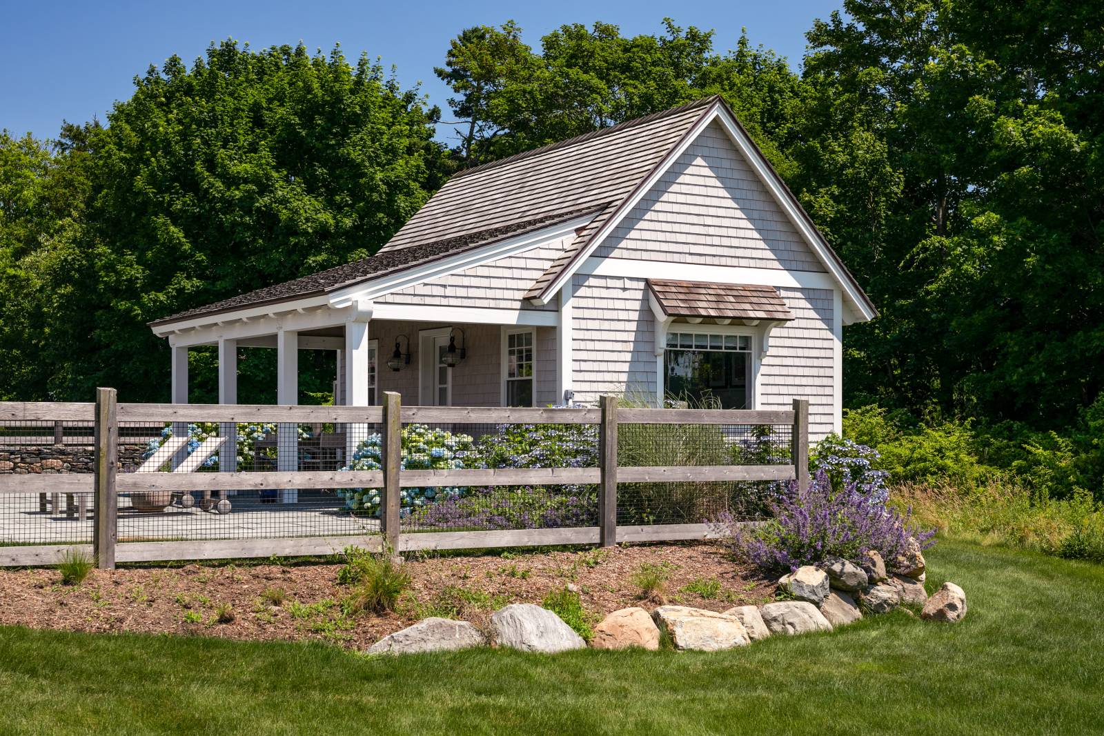 The custom pool house has a 9' porch roof overhang