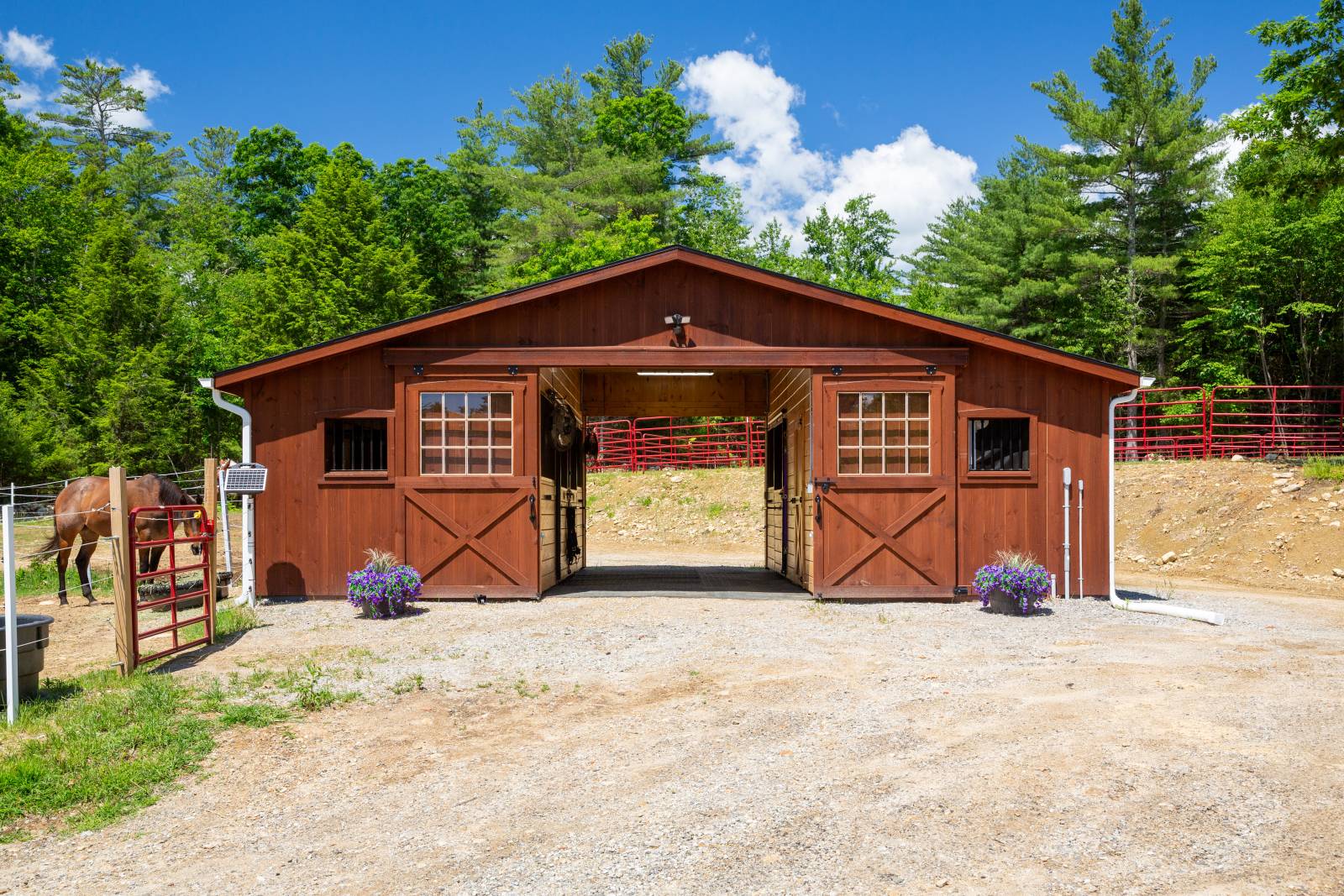 The Hampden Horse Barn has a center aisle design