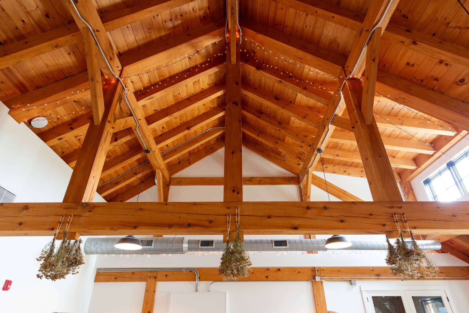 A closeup of the timber trusses within the community center