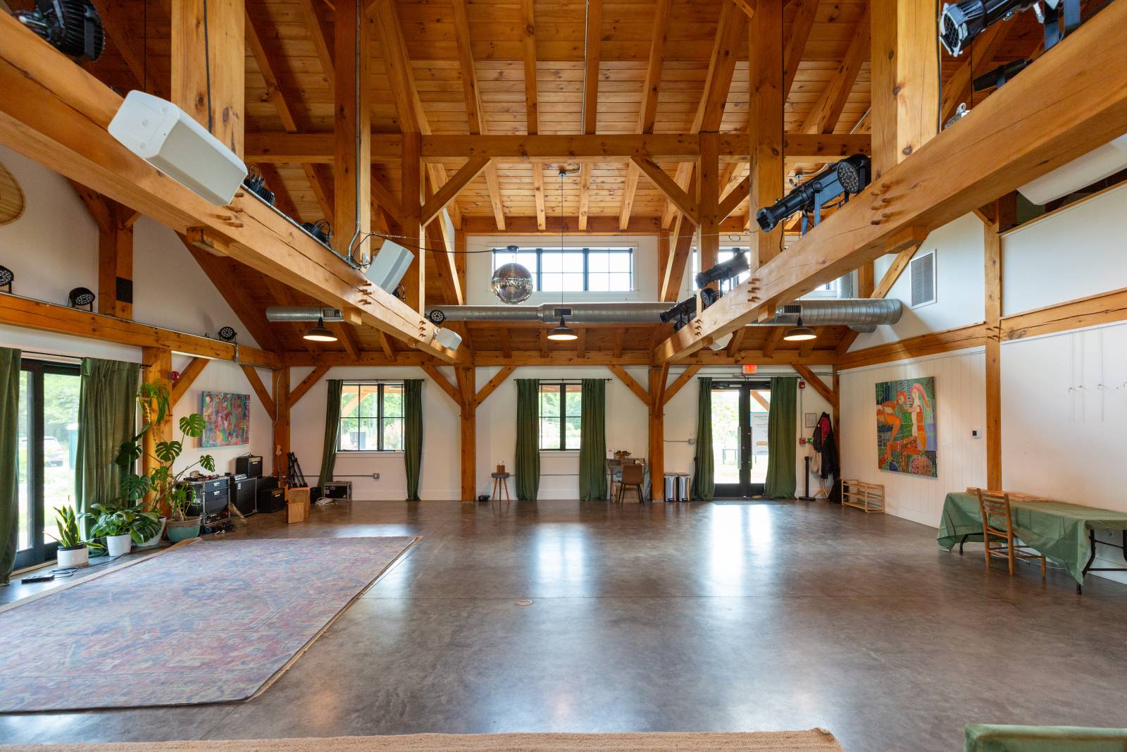 Massive timber trusses create a clear span area with no central posts