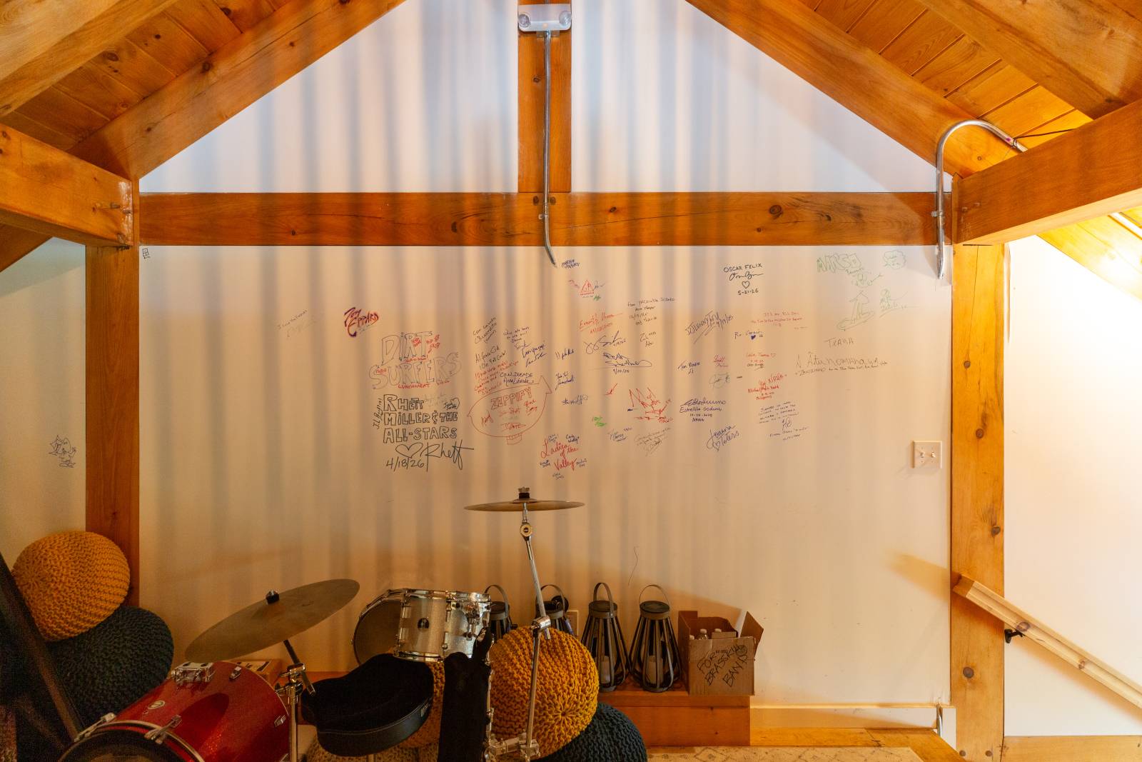 Performers at The Living Room make their mark on the wall within the loft