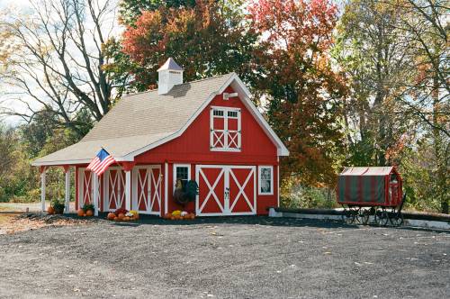 Original wheeled farm stand next to the new barn