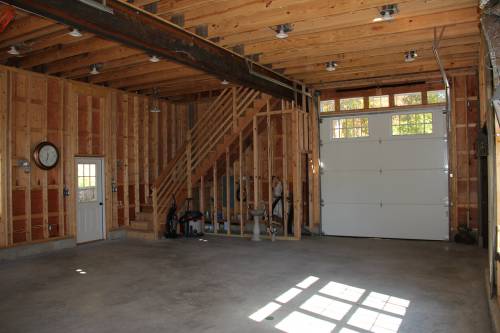 Construction-type stairway and garage door in rear of building