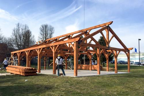 A shot from raising day showing the nearly-completed timber frame