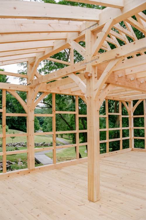 Post with arched kneebraces and wedged anchorbeam tenon joinery (the curved member)