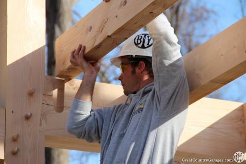 Ev Jr guides a dove tailed floor joist into place