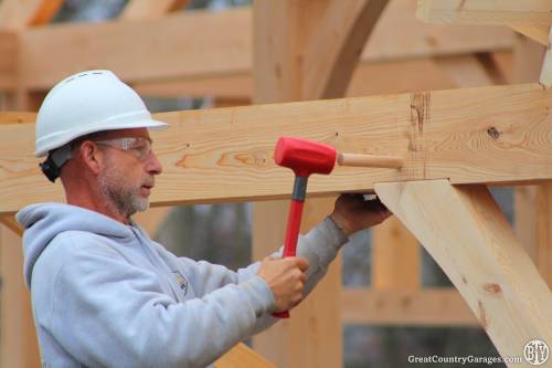 Charlie hammers in an oak peg