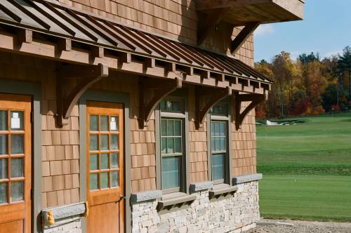 Timber frame eyebrow roof with copper standing seam