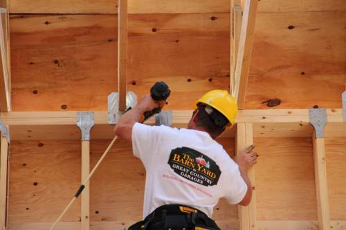 Crew anchoring roof trusses