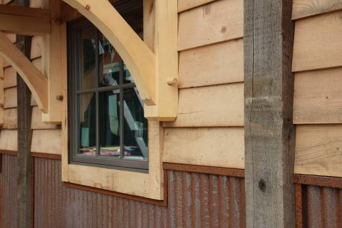 Reclaimed clapboard siding with reclaimed beams & rusty metal