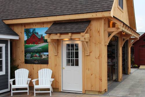 Notice the two timber frame eyebrow roofs on the custom garage