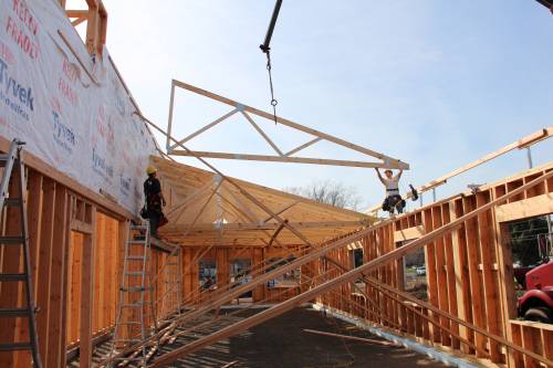 Ev Jr and Andy crane trusses over the offices