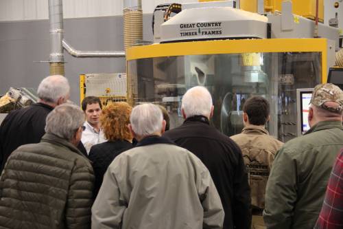 The crowd listens to Ev Jr talk about the CNC machine