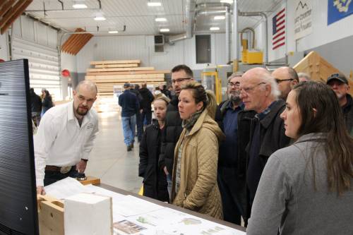 Visitors watch the monitor as Design Manager Jim and Designer Barbara demonstrate the design process