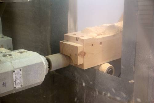 CNC machine crafting timber sill joinery on a Carriage Barn post