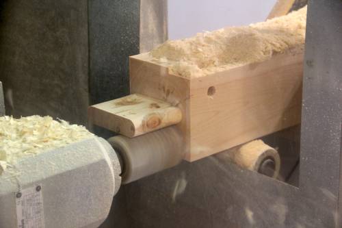 CNC machine crafting timber sill joinery on a Carriage Barn post