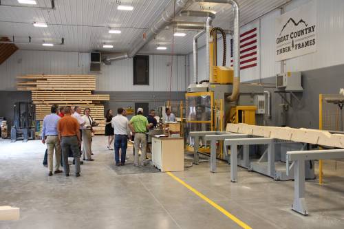 The group walking over to watch the CNC machine craft the pavilion