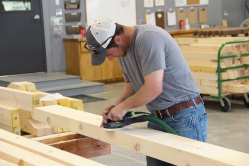 Carefully sanding the beams