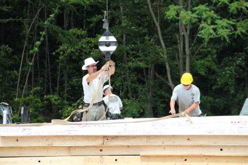 Norm attaches wall panel to crane