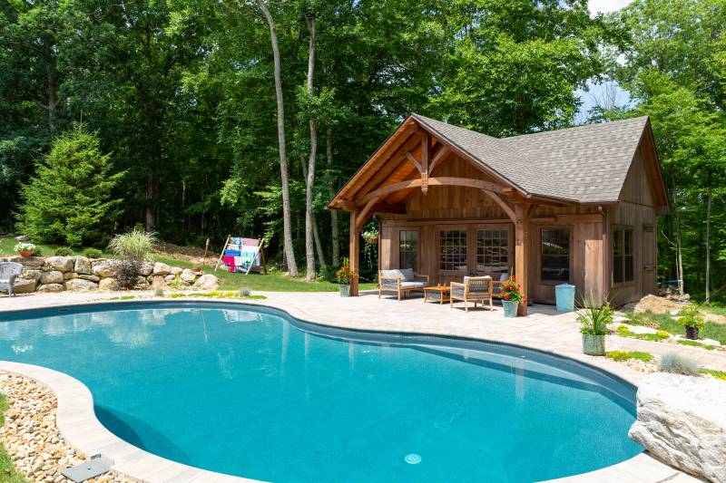 Rustic Pool House with Timber Frame Overhang