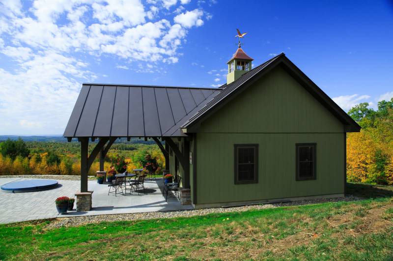 Side view of the pool house with timber frame porch