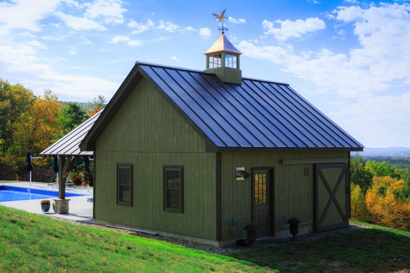 Rear of the timber frame pool house with barn-like details & cupola