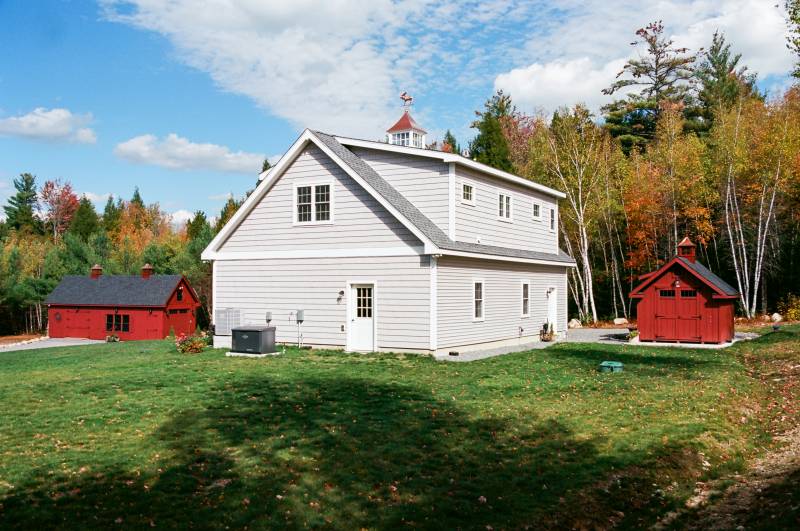 Side/Back of the Garage with Apartment and 2 Barn Yard Sheds